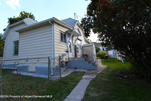 view of home's exterior with a lawn