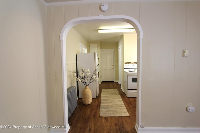 corridor featuring dark hardwood / wood-style floors and radiator heating unit