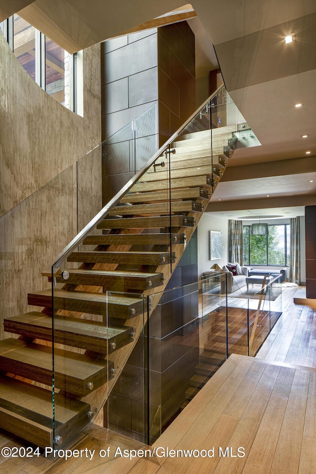 stairs featuring hardwood / wood-style flooring