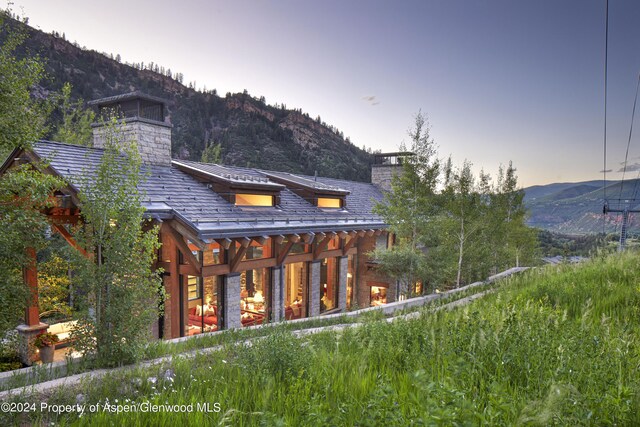 back house at dusk with a mountain view