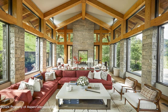 sunroom / solarium featuring vaulted ceiling with beams