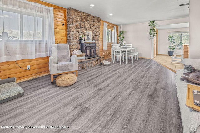 5904 County Road 31, Craig, CO 81625 - living area with a wood stove, wood finished floors, plenty of natural light, rustic walls, and recessed lighting
