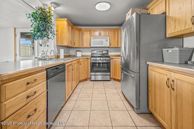 5904 County Road 31, Craig, CO 81625 - kitchen with stainless steel appliances, a sink, light countertops, and light tile patterned floors