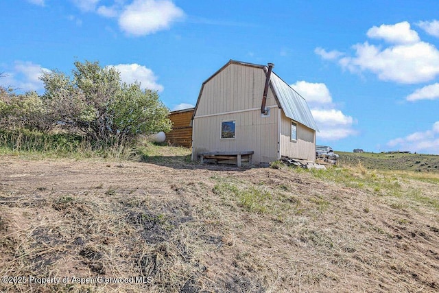 5904 County Road 31, Craig, CO 81625 - view of side of property featuring a gambrel roof, a barn, and an outbuilding