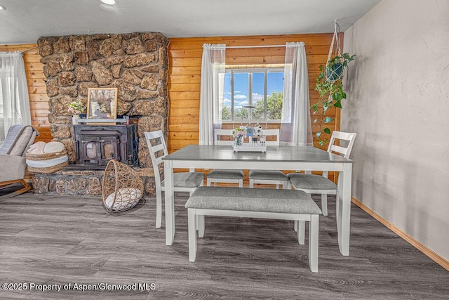 5904 County Road 31, Craig, CO 81625 - dining room with wood finished floors, a wood stove, and baseboards
