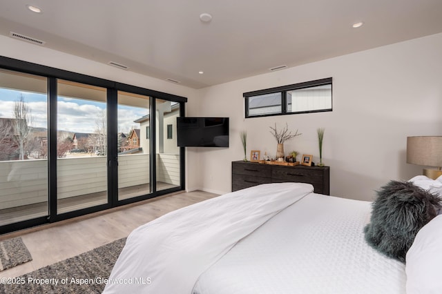 bedroom with access to exterior, recessed lighting, wood finished floors, and visible vents