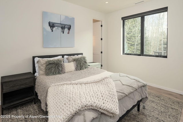 bedroom featuring visible vents, recessed lighting, baseboards, and wood finished floors