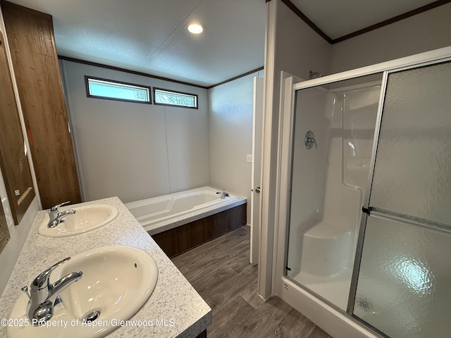 bathroom with independent shower and bath, ornamental molding, a textured ceiling, and hardwood / wood-style flooring