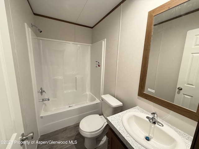 full bathroom with toilet, vanity, crown molding, and washtub / shower combination