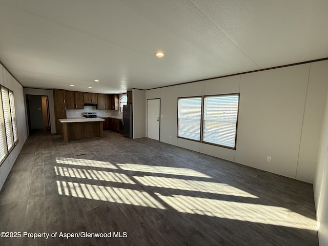 unfurnished living room with dark hardwood / wood-style flooring