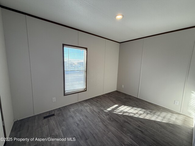 unfurnished room with dark hardwood / wood-style floors