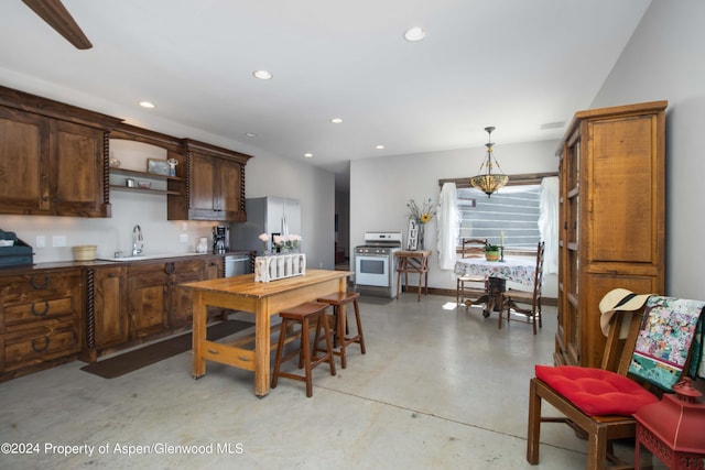 kitchen featuring decorative light fixtures, sink, and appliances with stainless steel finishes