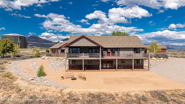 rear view of property with a deck with mountain view