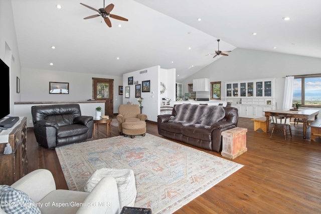 living room with dark hardwood / wood-style flooring, high vaulted ceiling, and ceiling fan