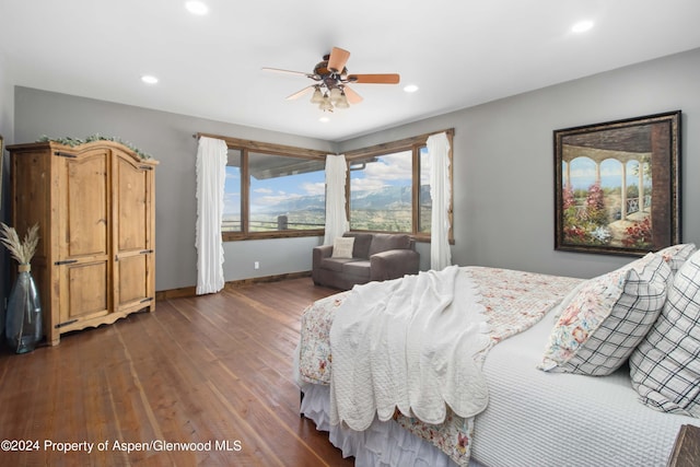 bedroom with ceiling fan and dark hardwood / wood-style floors