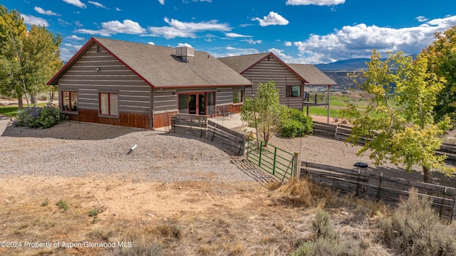 rear view of house featuring a mountain view