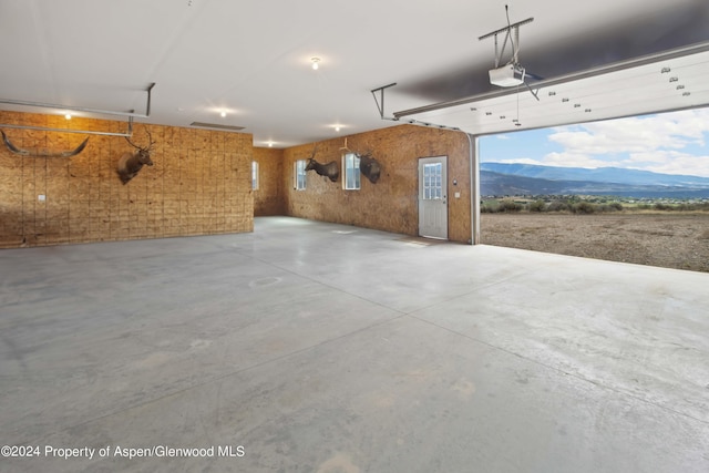 garage featuring a mountain view and a garage door opener