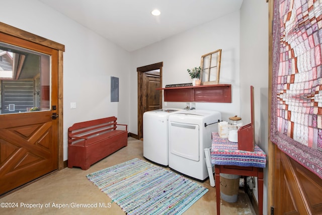 washroom with electric panel and washing machine and clothes dryer