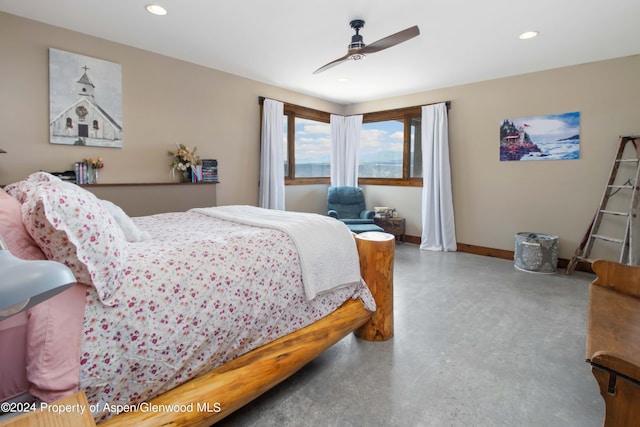 bedroom with ceiling fan and concrete floors