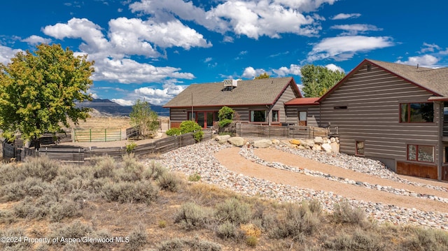 rear view of property featuring a mountain view