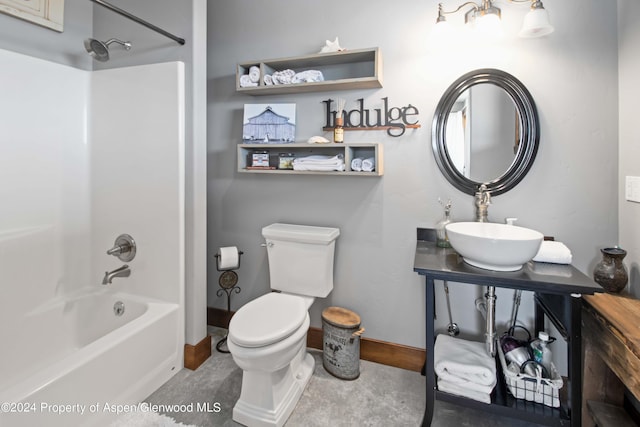 full bathroom with toilet, sink, and washtub / shower combination