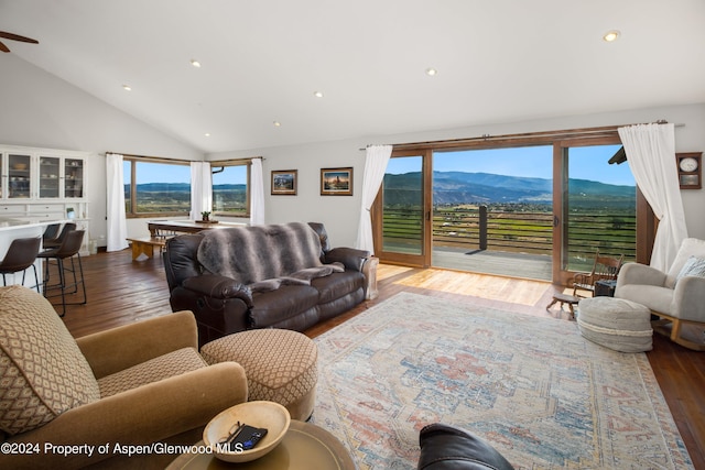 living room featuring hardwood / wood-style floors, a mountain view, and high vaulted ceiling