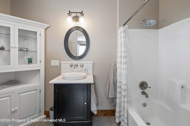 bathroom with shower / tub combo and vanity