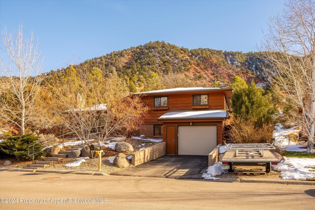 view of front of house featuring a mountain view and a garage