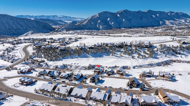 snowy aerial view with a mountain view