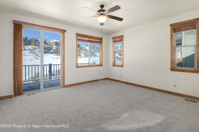 unfurnished room featuring carpet and ceiling fan