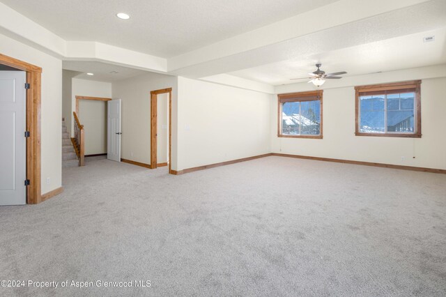 carpeted spare room with ceiling fan