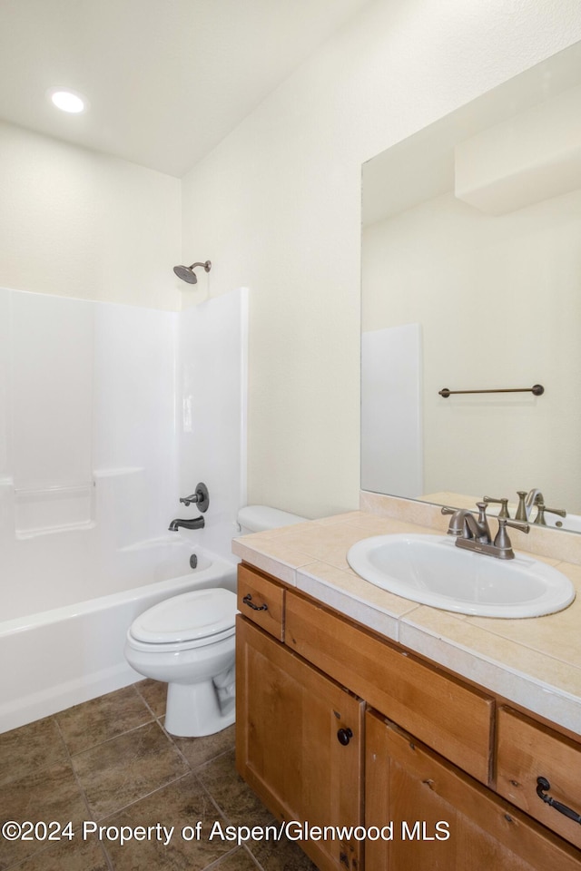 full bathroom with toilet, vanity, and tub / shower combination