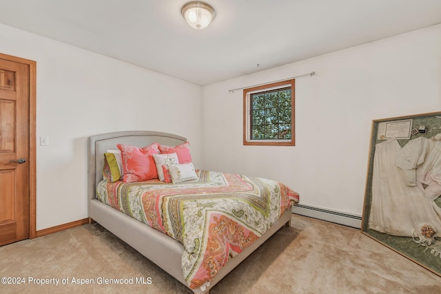 bedroom featuring light colored carpet and baseboard heating