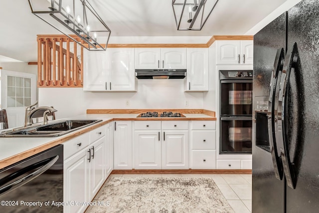 kitchen with white cabinetry, sink, light tile patterned flooring, and black appliances