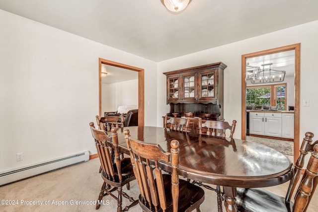 carpeted dining area with baseboard heating and a chandelier