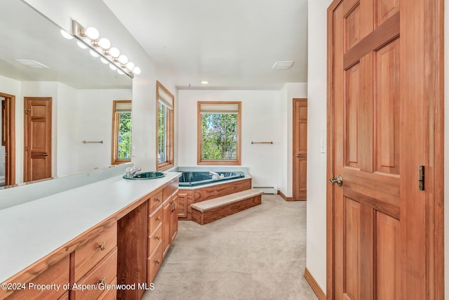 bathroom featuring a tub, vanity, and a baseboard heating unit