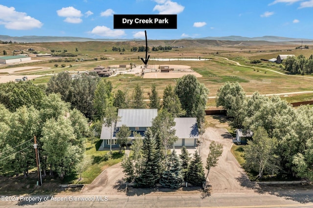 birds eye view of property with a mountain view and a rural view