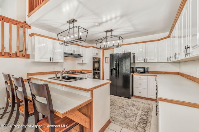 kitchen featuring kitchen peninsula, white cabinetry, pendant lighting, and black appliances