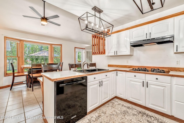 kitchen featuring kitchen peninsula, sink, pendant lighting, black dishwasher, and white cabinetry