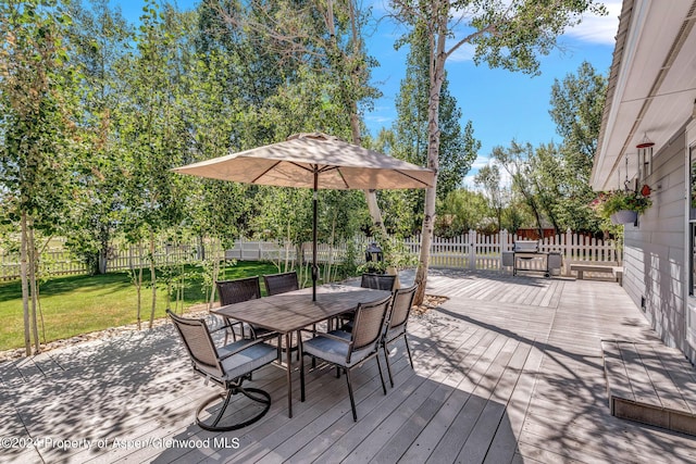 wooden deck featuring a yard