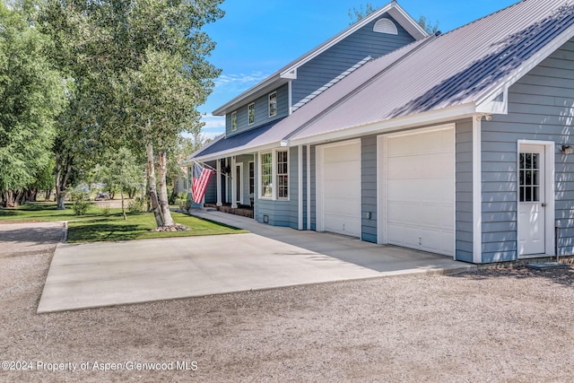 view of side of home with a garage and a lawn