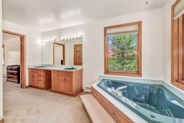 bathroom with vanity, a bath, and a baseboard heating unit