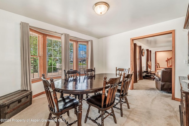 dining area featuring light carpet