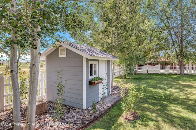 view of outbuilding with a yard