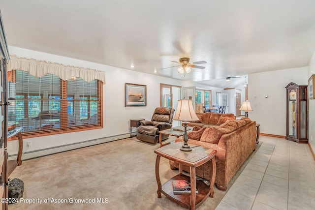 tiled living room featuring ceiling fan, baseboard heating, and a wealth of natural light