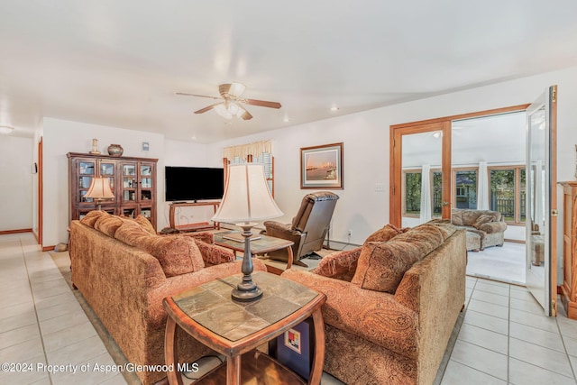 living room with ceiling fan, light tile patterned floors, and baseboard heating