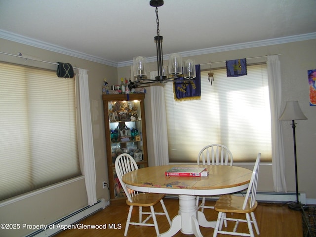 1558 E 12th St, Rifle, CO 81650 - dining room featuring a baseboard heating unit, wood finished floors, crown molding, a baseboard radiator, and a chandelier