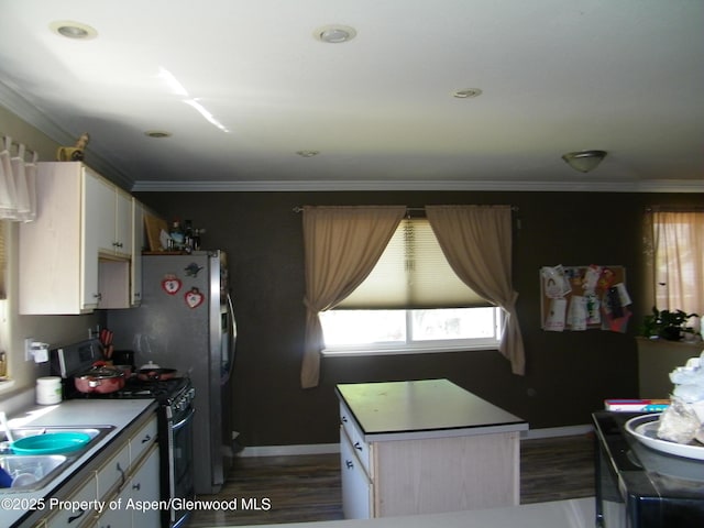 1558 E 12th St, Rifle, CO 81650 - kitchen featuring black gas stove, dark wood-style floors, plenty of natural light, and crown molding