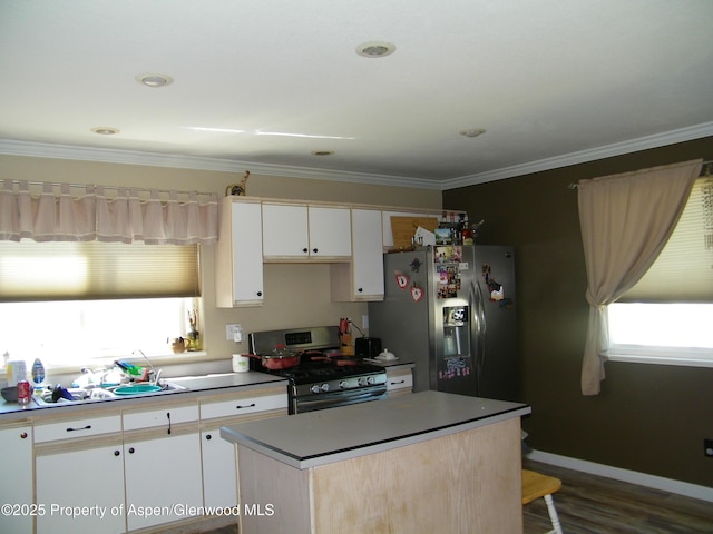 1558 E 12th St, Rifle, CO 81650 - kitchen with stainless steel appliances, crown molding, a kitchen island, white cabinets, and dark wood finished floors