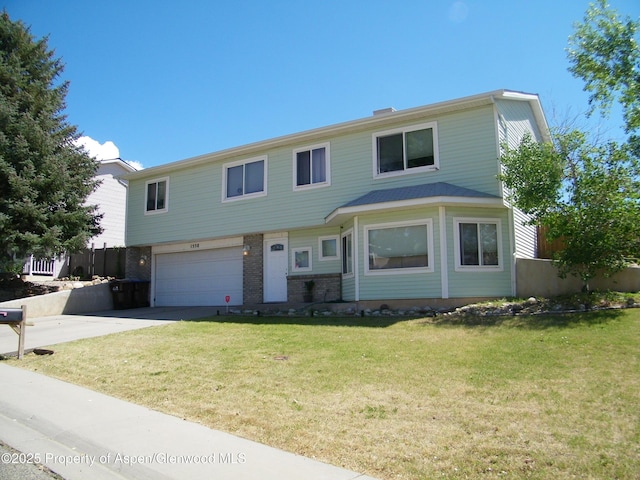 1558 E 12th St, Rifle, CO 81650 - view of front of house featuring a garage, concrete driveway, and brick siding